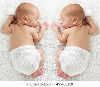 Newborn Twin Babies, Sleeping On A White Blanket. 