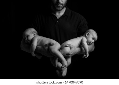 Newborn Twins In The Arms Of Dad, Black And White Portrait