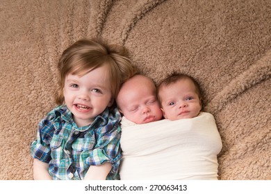 Newborn Twins And Their Older Sibling