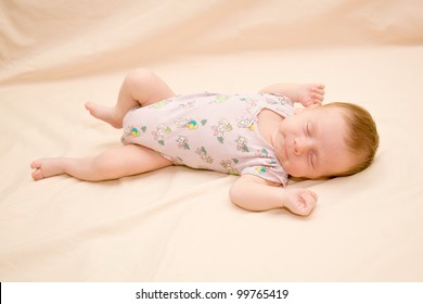 Newborn Wearing A Bodysuit, Sleeping Soundly On His Back, Stretched Hands.