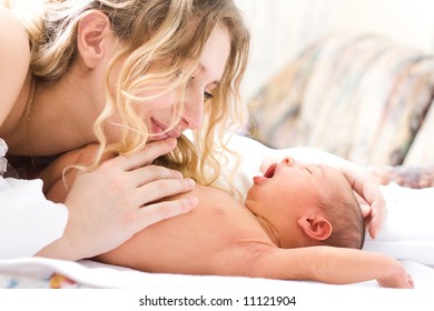 Newborn yawning child with mother