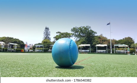 Newcastle, Australia - Feb 2020: View Of The Blue Lawn Bowls Balls On Green Synthetic Lawn With Blue Sky Background. Lawn Bowling Is A Outdoor Sport At Australia