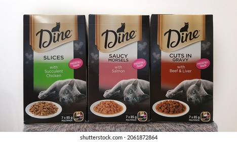 Newcastle, Australia - Oct 2021: View Of Variety Flavour Boxes Of Dine Daily Slices Trays Wet Cat Food In Wooden Background. Box Of Wet Cat Food Formula Combines Finely Sliced Pieces Of Real Meat 