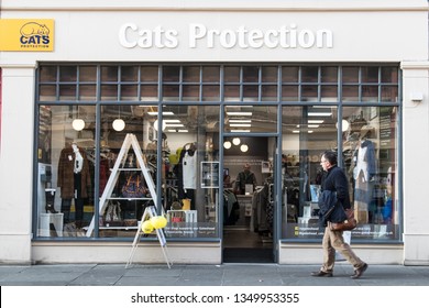 Newcastle / Great Britain - February 27, 2019: Exterior Of Cats Protection Charity Shop Showing Logo, Sign, Signage, Branding, Window Display And Entrance With Person Walking Past