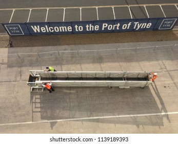 NEWCASTLE, UK - JULY 21, 2018, Work Men Wheel Away A Gang Plank From A Cruise Liner