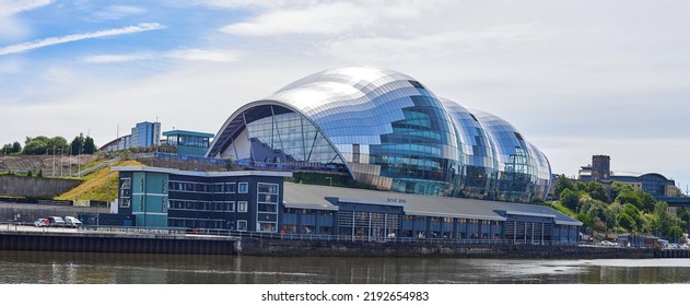 Newcastle Upon Tyne, UK, 11 July 2022 - Sage Concert Hall In Newcastle Upon Tyne Quayside. Sage Gateshead. The Curved Glass And Stainless Steel Building. Newcastle Cityscape.