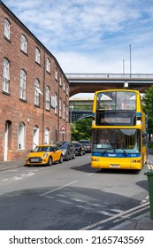 Newcastle upon Tyne, UK - June 3rd, 2022: People travelling on the Toon Tours open top bus on Lime Street in the Ouseburn cultural quarter.
