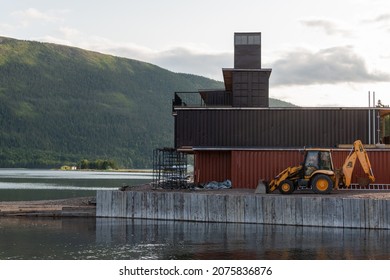 Newfoundland, Canada-November 2021: The Exterior Construction Of A Hotel Using Shipping Containers As Modular Construction. Recycled Brown And Orange Metal Ocean Sea Cans Stacked To Build A New House.