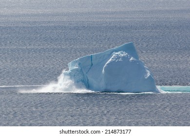 Newfoundland Coastal Iceberg Collapsing And Producing Waves.