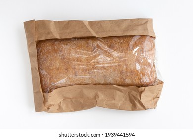 Newly baked Italian ciabatta bread from wheat flour in package on white background. Top view flat lay