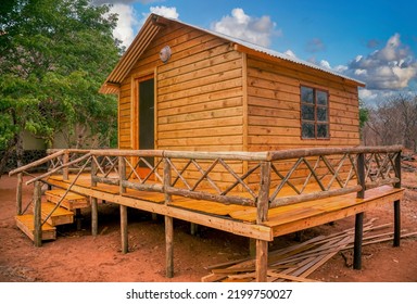 Newly Build Wood Cabin On Poles In Construction, With A Large Porch Veranda