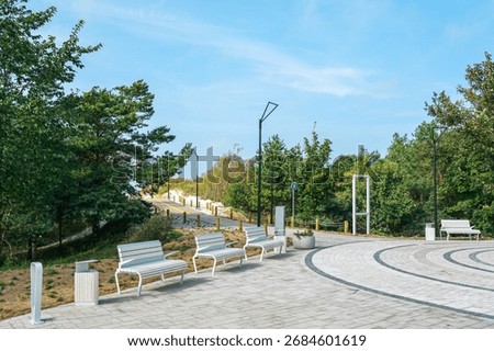 Newly built beach access infrastructure in Liepaja, Latvia, with benches, lights, and paved paths leading to the Baltic Sea dunes