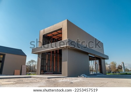 Newly built metal framed building with siding. Construction of a new tiny house. selective focus