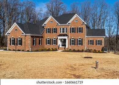 Newly Constructed Colonial Mansion Single Family Home, With Brick Facade, 2 Peak Gables, Landscape, Curb Appeal, Arched Windows In A Luxury Neighborhood Street In Maryland USA