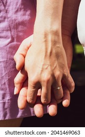 Newly Engaged Couple Holding Hands 