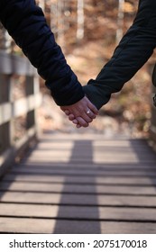 A Newly Engaged Couple Holding Hands