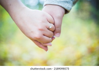 A Newly Engaged Couple Holding Hands