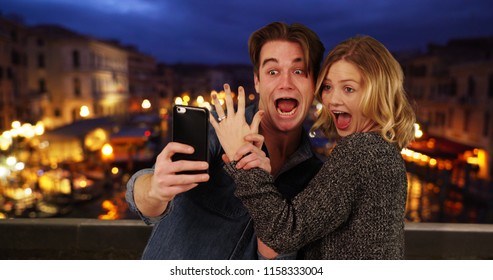 Newly Engaged Couple Taking A Selfie By The Grand Canal At Night