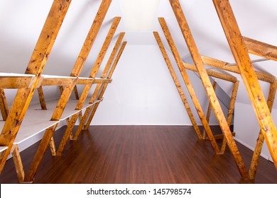 Newly Finished Empty Attic Storage Waiting To Be Filled With Boxes And Clothes. Stained Web Members And Laminate Flooring