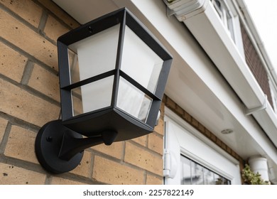 Newly installed multi-coloured smart lighting lamp seen outside a rear kitchen door. - Shutterstock ID 2257822149