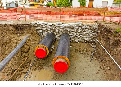 Newly Laid Pipe Are Passing Under The Road Trough Sandbag Wall In Trench