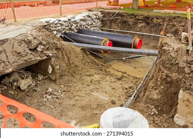 Newly Laid Pipe Are Passing Under The Road Trough Sandbag Wall In Trench