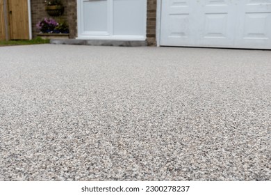 Newly laid resin driveway in front of a detached residential property