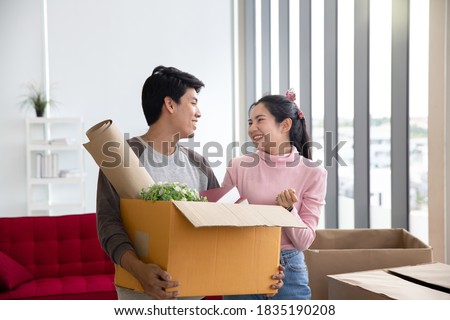 Newly married couples are setting up and decorating their new home. Moving to a new home.