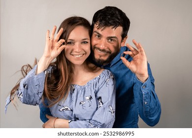 Newly married young couple showing their wedding rings. Happy married couple. Husband and wife showing their wedding rings - Powered by Shutterstock