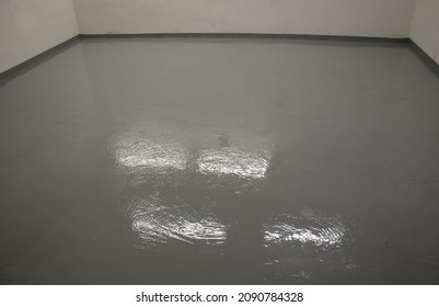 Newly Painted Garage Floor With Gray Latex Paint. The Surface Is Glossy And Easy To Maintain And Wash. Resistant To Oil And Chemicals. It Looks Wet And Shines