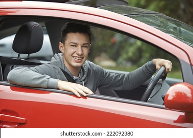 Newly Qualified Teenage Boy Driver Sitting In Car