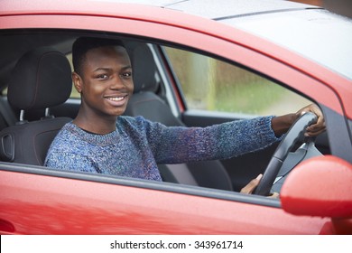 Newly Qualified Teenage Boy Driver Sitting In Car