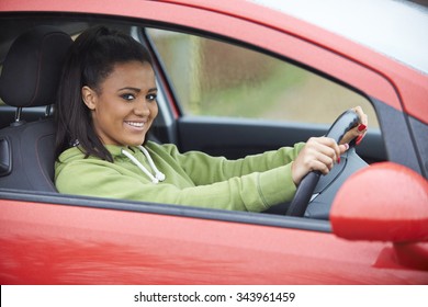 Newly Qualified Teenage Girl Driver Sitting In Car