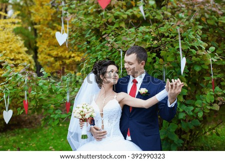 newly-married couple  on green grass in field