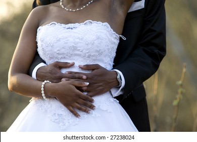 An newly-wed African-American couple holding each other
