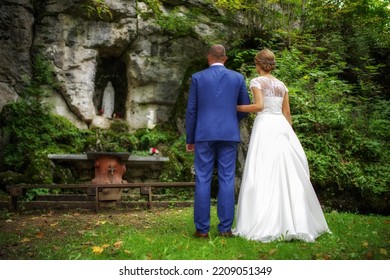 Newlywed Couple. Bride And Groom Standing Outdoor In Front Of Altar And Praying Together.