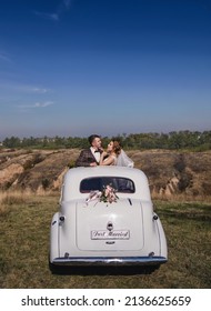 A Newlywed Couple In Car Sunroof Retro Car , Rear View