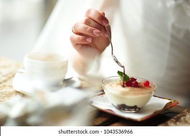 A newlywed couple drinking hot coffee or tea with sweet dessert in warm cozy cafe with wedding bouquet on the table. Atmoshere of happiness of new family and love tenderness - Powered by Shutterstock