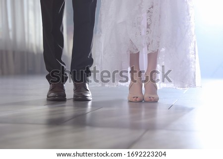 Newlywed couple in festive hall, closeup of legs
