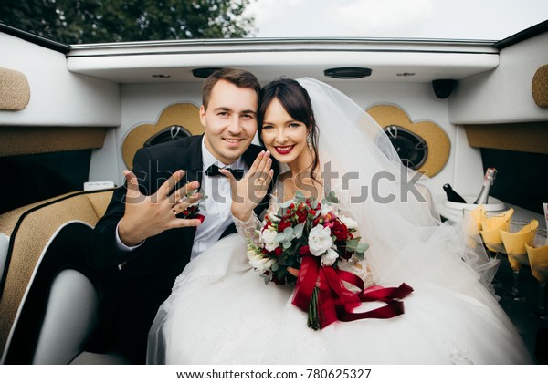 Newlywed in a luxury\
wedding limousine