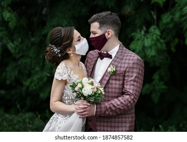 Newlyweds after marriage registration in masks, during a coronavirus infection
