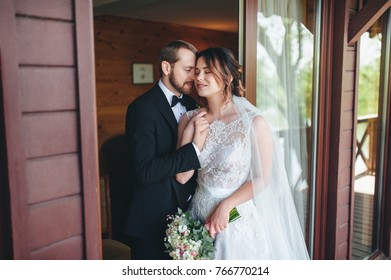 Newlyweds Embracing At The Door Of The Hotel. Gentle Embrace Of The Newlyweds.