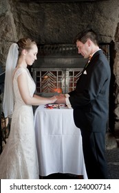 Newlyweds Holding Hands, Saying Wedding Vows