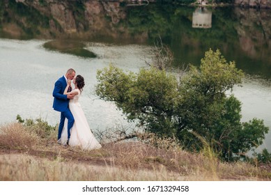 newlyweds near the river and hills