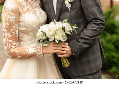 Newlyweds at wedding day, wedding couple with wedding bouquet of flowers, bride and groom