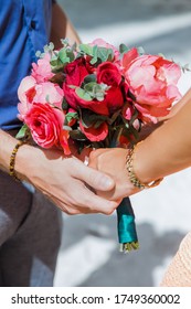 Newlyweds At The Wedding Romantic Couple Holding Hands During Destination Wedding Marriage Matrimonial Ceremony On The Sandy Beach In Dominican Republic, Punta Cana. Family, Love, Unity Concept.  