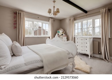 Newmarket, Suffolk - March 11 2019: Beautiful Stylish Luxury Bedroom Dressed With Stylish Furniture And Soft Furnishings Including Faux Fur Bedspread, Dressing Table And Dual Aspect Windows