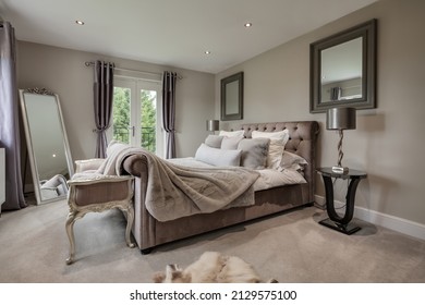 Newmarket, Suffolk - March 11 2019: Beautiful Stylish Luxury Bedroom Dressed With Stylish Furniture And Soft Furnishings Including Faux Fur Bedspread