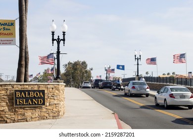 Newport Beach, CA, USA - May 8, 2022: Cars move slowly to enter the Balboa Island in Newport Beach, California, via the Balboa Island Channel Bridge on a sunny day.