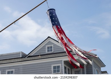 Newport Beach, CA, USA - May 8, 2022: American Flag Windsock Is Seen Hanging Out In Front Of A House On The Balboa Island In Newport Beach, California.